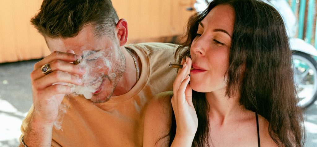 Learn how to smoke a cigarillo, a couple both smoking a cigarillo for first time