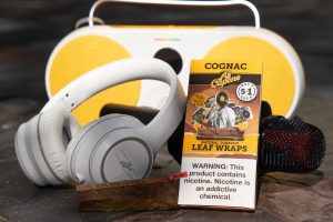 Al Capone limited edition promotional natural leaf wraps and some instruments on a wooden outdoor table in summer sunlight