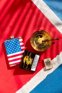 Super Bowl party spread with big screen TV, snacks, drinks, football décor, and Al Capone cigarillos set out for adults