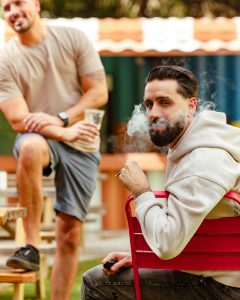 Super Bowl party spread with big screen TV, snacks, drinks, football décor, and Al Capone cigarillos set out for adults