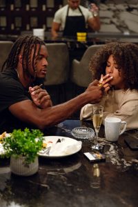 Home casino night setup with roulette wheel, poker chips, cocktails, and Al Capone cigarillos displayed for adult guests