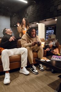 er Olympics Ideas: Legendary Games for Unforgettable Gatherings
Alt Text: Backyard Beer Olympics setup with teams in matching shirts, drinking games, coolers of drinks, and Al Capone cigarillos offered for adults