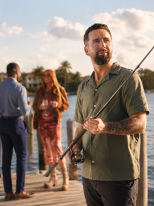  Fishing gear laid out on a dock with tackle box, cooler, sunscreen, and optional Al Capone cigarillos for adults