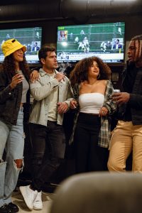 Friends gathered around a big screen for a boxing watch party