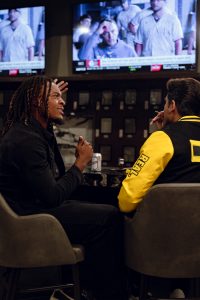 Friends gathered around a big screen for a boxing watch party