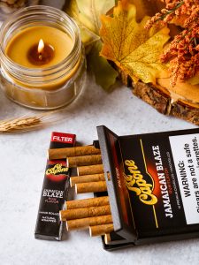 Thanksgiving weekend table with dinner spread, football on in the background, and Al Capone cigarillos for the after-dinner tradition